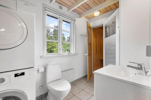 a white bathroom with a toilet and a sink at LF16183-Logstor-Monasvej-1 in Løgstør