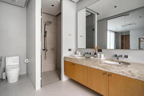 a bathroom with a sink and a toilet and a mirror at Botanica Zen by Villacarte in Ban Phru Champa