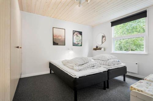 a bedroom with a bed in a room with a window at LF16244-Logstor-Mollysvej-44 in Løgstør