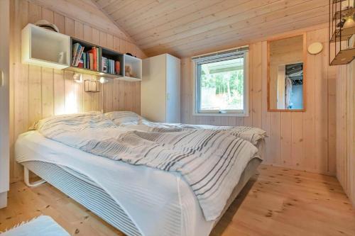 a bed in a small room with a window at 13346-Hojby-Digevaenget-8 in Højby