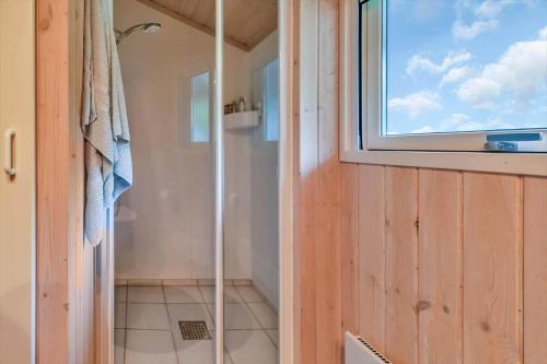 a shower in a bathroom with a window at 13346-Hojby-Digevaenget-8 in Højby