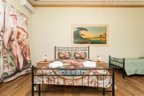 a bed in a room with paintings on the wall at Etnamia Art in Paterno