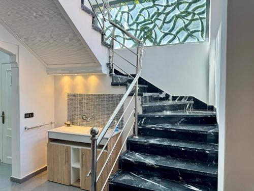a bathroom with a staircase with a glass wall at Atlas View Luxury Villa in Ourika