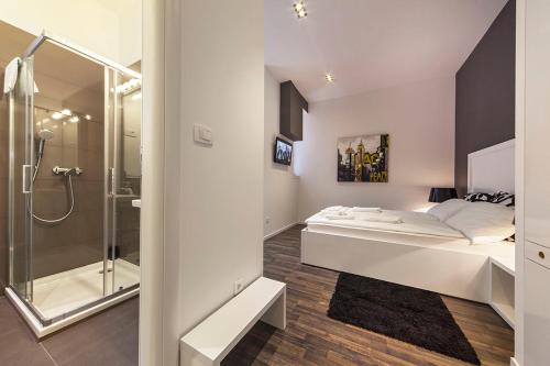 a bedroom with a bed and a glass shower at Priuli Luxury Rooms in Split