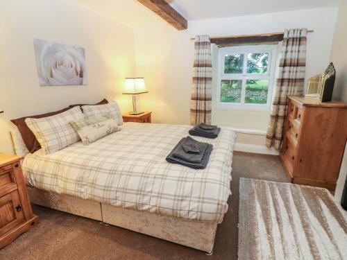 a bedroom with a bed and a window at The LA'AL Cragg in Kirkby Stephen