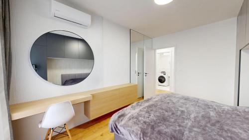 a bedroom with a mirror and a bed and a chair at Candy 3 in Trnava