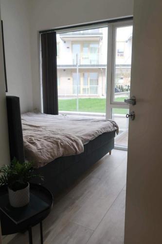 a bedroom with a bed and a large window at Modern Apartment Bergen Centrum in Bergen