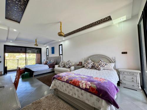 a bedroom with a bed and a living room at Atlas View Luxury Villa in Ourika
