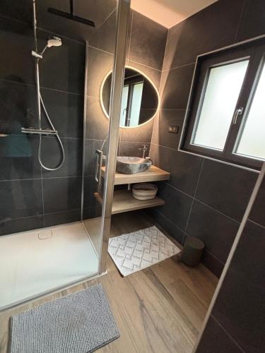 a bathroom with a shower and a sink at Le Petit Nid Gerardmer in Gérardmer