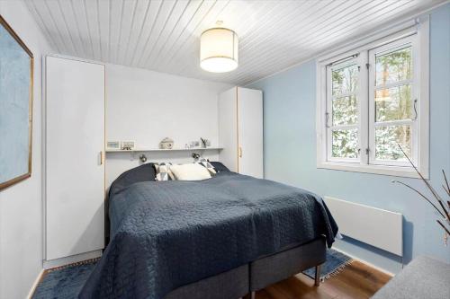 a bedroom with a bed and two windows at LF16240-Logstor-Mollysvej-10 in Løgstør