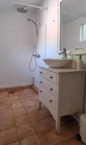 a bathroom with a white sink and a shower at 10040-Rorvig-Lyngvaenget-10 in Rørvig