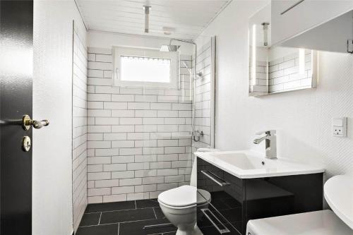 a white bathroom with a toilet and a sink at LF593-Vestervig-Ingeborgs-Alle-21 in Vestervig