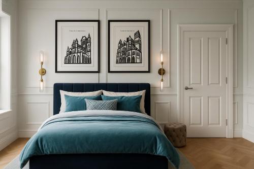 a bedroom with a blue bed with three pictures on the wall at The Bridge York in York