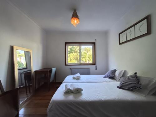 a bedroom with two beds and a window at Concha de Moledo in Moledo