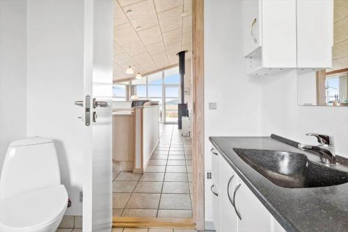 a white kitchen with a sink and a toilet at LF626-Snedsted-Kongens-Borer-4 in Snedsted