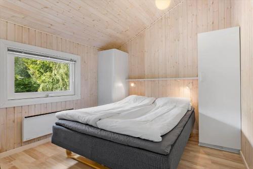 a bedroom with a bed in a room with a window at LF15147-Farso-Ramshule-47 in Farsø