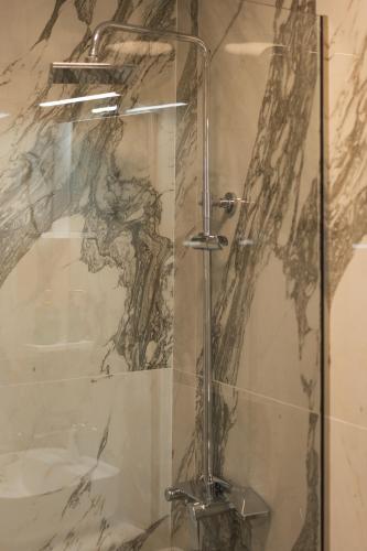 a shower with a glass door in a bathroom at Traditional House in Mytilene Center in Mytilene