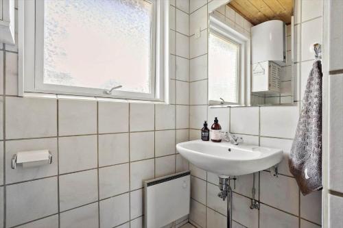 a white bathroom with a sink and a window at LF15194-Hojslev-Spaettevej-14 in Højslev