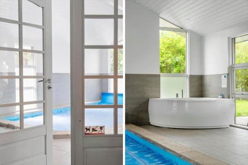 a bathroom with a tub and a swimming pool at LF634-Vestervig-Gunhildsvej-54 in Vestervig