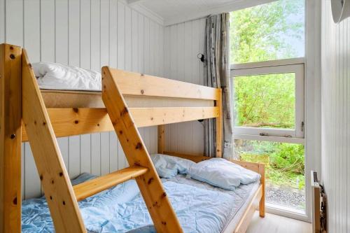 a bedroom with two bunk beds and a window at LF634-Vestervig-Gunhildsvej-54 in Vestervig