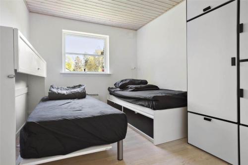 a bedroom with two beds and a window at 13328-Vig-Lillemosevej-5 in Vig