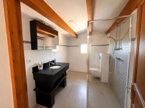 a bathroom with a black sink and a shower at Villa d'exception sur la plage - Tizzano in Sartène