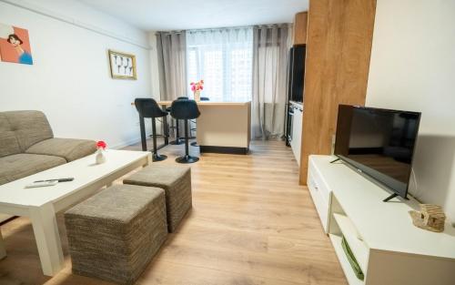 a living room with a couch and a flat screen tv at Apartman Lili in Knin