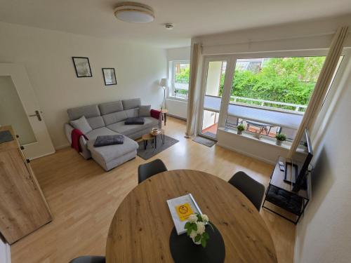a living room with a table and a couch at FeWo Büsum No 12 in Büsum