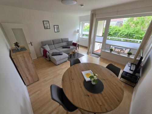 a living room with a wooden table and a couch at FeWo Büsum No 12 in Büsum