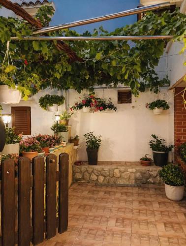 a patio with potted plants on the side of a building at Yasmin Breeze Apartment in Nerezine