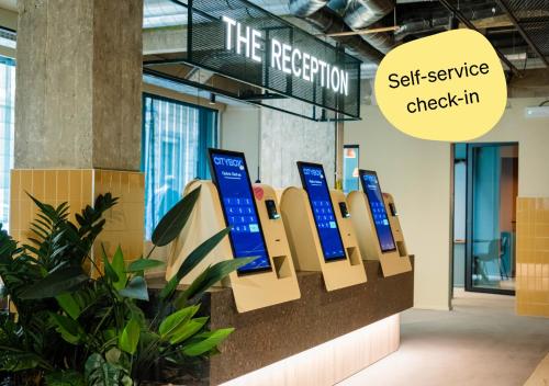 a sign that says the reception self service check in at Citybox Brussels Centre Louise in Brussels