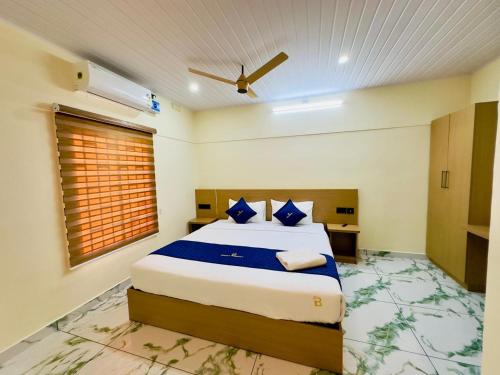 a bedroom with a large bed in a room at Breeza Residency in Kazhakuttam