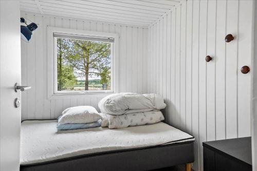 a bed with two pillows and a window in a room at LF15197-Hojslev-Venovej-36 in Højslev