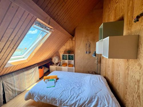 a bedroom with a bed in a room with a window at Domaine d'Equital'Or in Cressanges