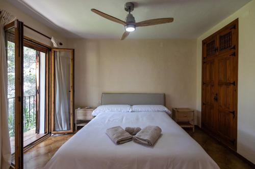 a bedroom with a bed with two towels on it at Javea Vedat by Concept Flats in Jávea