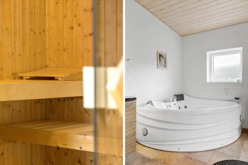 a bathroom with a white tub and a wooden wall at LF229-Vestervig-Hannesvej-16 in Vestervig