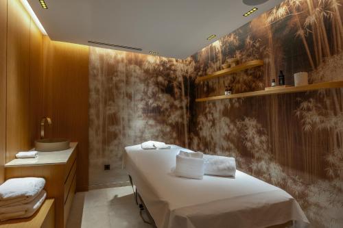 a room with a bed and a sink at ZEM Wellness Clinic Altea - 5 Stars Grand Luxury in Altea