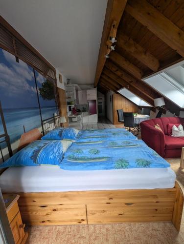 a bedroom with a large bed with a blue comforter at Gästehaus Regina in Ruhla