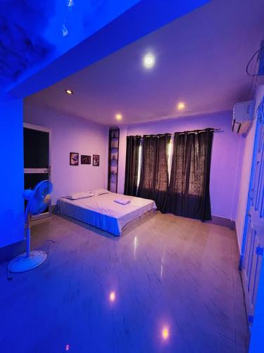 a bedroom with a bed in a purple room at The Cloud9 Villa in Tezpur