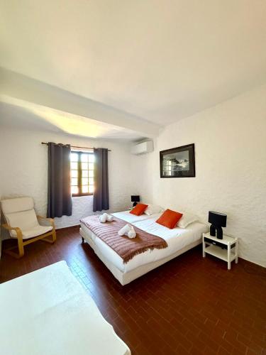 a large bedroom with a large bed and a window at Maison avec vue mer à Propriano in Propriano