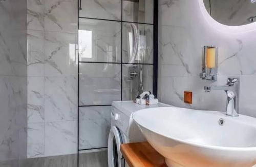 a white bathroom with a sink and a shower at Villa Marcella by the Sea in Kamisianá