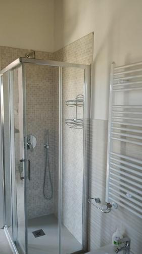 a shower with a glass door in a bathroom at Oasi 29 in Morlupo