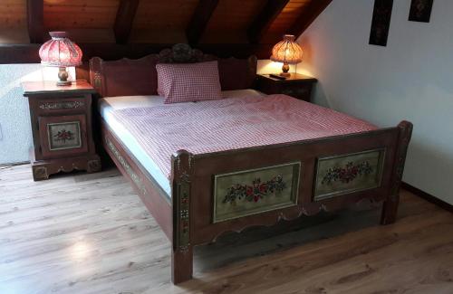 a bedroom with a large bed with two night stands at Hotel Bären Bern-Neuenegg Self-Check-In in Neuenegg