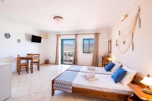 a bedroom with a large bed and a table at Giota's Studio in Karpathos