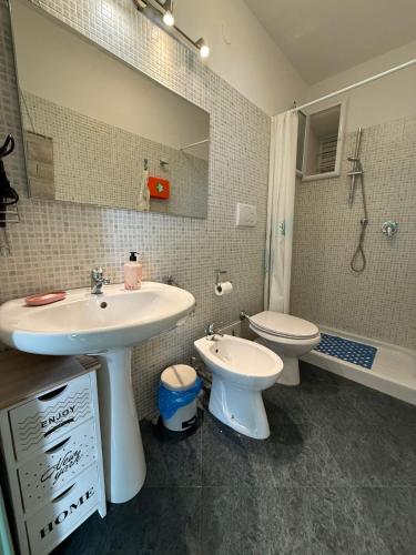 a bathroom with a sink and a toilet and a mirror at Domus Lucrezia in Bisceglie