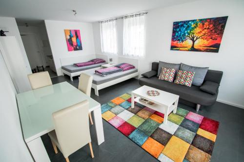 a living room with a couch and a table at Murthum Apartments in Leinfelden-Echterdingen