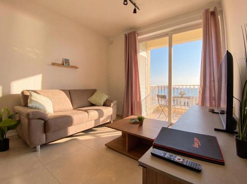 a living room with a couch and a table at Merhba Court Apartments - St Pauls Bay in St. Paul's Bay