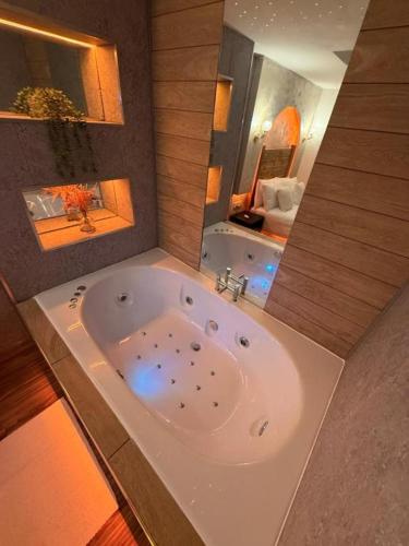 a large bath tub in a bathroom with a tub at Mansa Halifax in Halifax