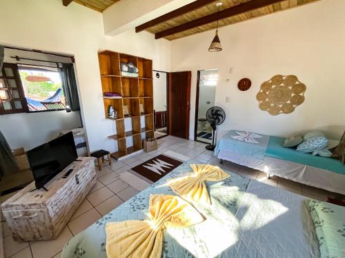 a living room with two beds and a couch at Loft NOA'House in Canoa Quebrada