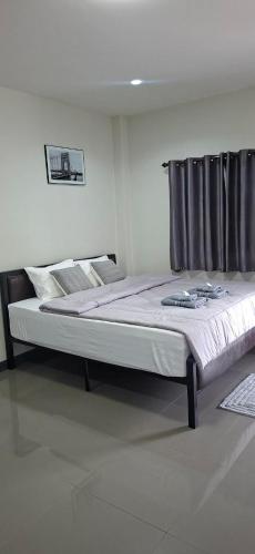 a large bed in a bedroom with at TR Hotel Udon Thani in Ban Dong Kheng